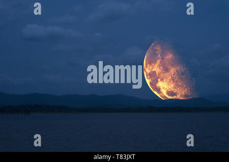 half moon floating in sky back on silhouette mountain ,Elements of this image furnished by NASA Stock Photo