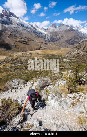 Hiker going up through the magnificent and steep high mountain landscape on the Laguna 69 hike, Huascaran National Park, Ancash Region, Peru Stock Photo