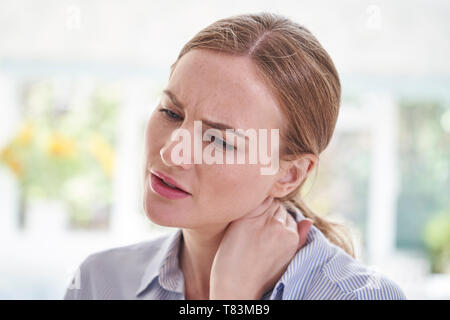 Close Up Shot Of Young Woman Suffering With Neck Ache Stock Photo