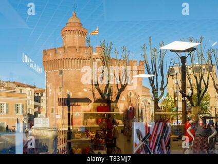 France, Pyrenees Orientales, Perpignan, city center, reflection of the Castillet in a window at sunset Stock Photo