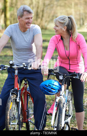 Mature Couple On Cycle Ride In Countryside Together Stock Photo