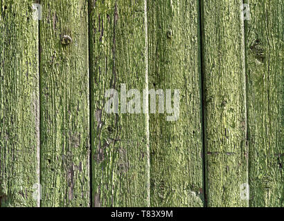 Old rough wooden planks with cracks as background. Wooden boards texture with the exfoliating green paint Stock Photo