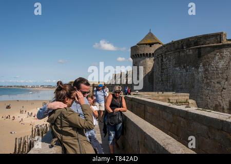 Tourist walking on ramparts of Intra Muros Saint Malo, Brittany, France Stock Photo