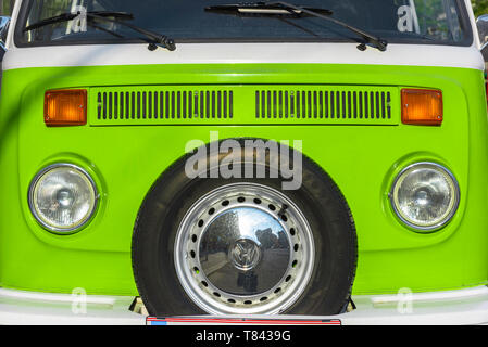 VW camper, view of the front of a classic 1970s VW camper van in bright green. Stock Photo