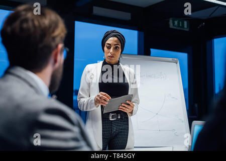 Businesswoman using digital tablet during office presentation Stock Photo