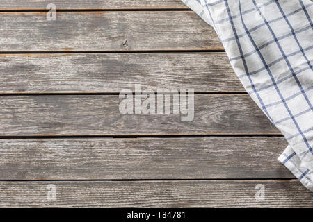 Blue white checketed tablecloth on wooden kitchen table - top of view Stock Photo