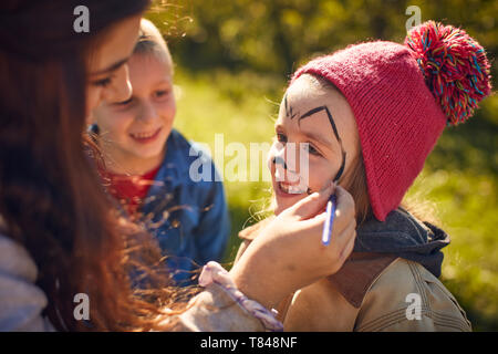 Girl getting face painted Stock Photo