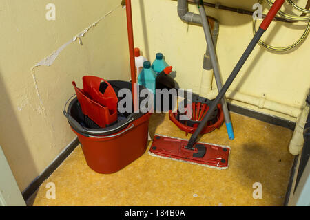 Cleaning supplies and tools arranged in storage place in a office Stock Photo