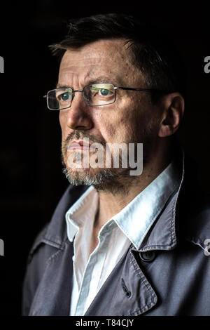 Close up portrait of senior man wearing glasses looking away. Stock Photo