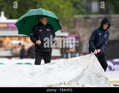 The Grange, Edinburgh, Midlothian, UK. 10th May 2019. Scotland v Afghanistan ODI. Pic shows: 3rd umpire, Alan. Haggo looks on as the covers are brought onto the field as rain stops play during the second innings as Scotland take on Afghanistan in a One Day International at the Grange, Edinburgh Credit: Ian Jacobs/Alamy Live News Stock Photo