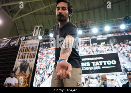 athens attica greece 10th june 2019 a man seen showing his new tattoo during the eventthe athens tattoo convention is a three day annual convention about tattoo and it takes place in athens greece it has been recognized as one of the best in europe with visitors from all over the world who come exclusively for the athens tattoo convention experience and also to meet some of the worlds most respected tattoo artists credit nikos pekiaridissopa imageszuma wirealamy live news t84j46