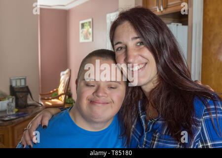Teen boy who has Down Syndrome standing with his friend Stock Photo