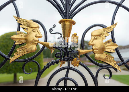 Close-up of gilded, winged wind images, a detail of the wrought-iron gates at Powerscourt, Enniskerry, County Wicklow, Republic of Ireland Stock Photo