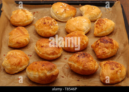 Freshly baked ruddy buns cool on the table. Stock Photo
