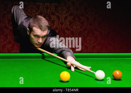 Snooker player taking a shot Stock Photo