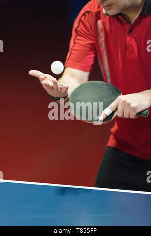 Table tennis player serving Stock Photo