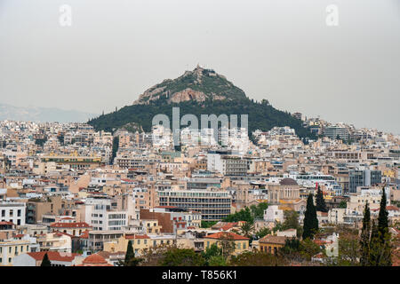 View from Acropolis on cityscape of Athens and Lycabettus Hill, known as Lykabettos. It is a Cretaceous limestone hill in Athens Greece Stock Photo