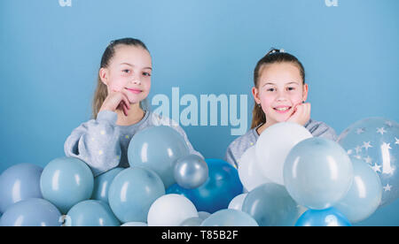 Sisters organize home party. Having fun concept. Balloon theme party. Girls best friends near air balloons. Start this party. Birthday party. Happiness and cheerful moments. Carefree childhood. Stock Photo