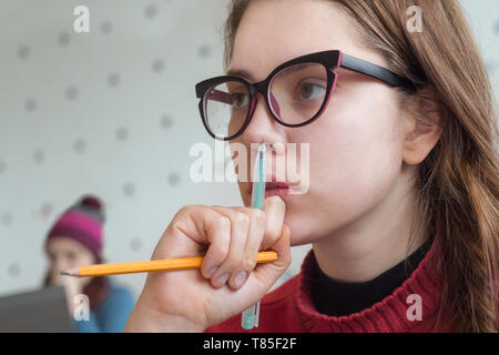 Thoughtful student at the university. Portrait of thinking female listening to lecturer, teacher, professor. Hipster girl learning, studying in Stock Photo