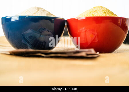 Nigerian yellow and white Garri in Bowls at marketplace - ready to sell Stock Photo