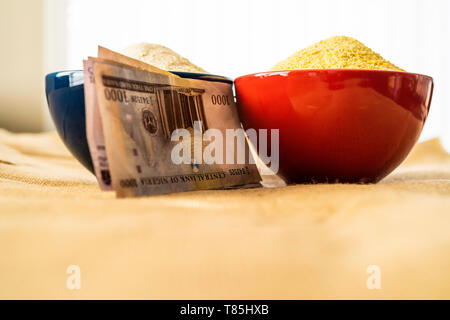 Nigerian yellow and white Garri in Bowls at marketplace - ready to sell Stock Photo