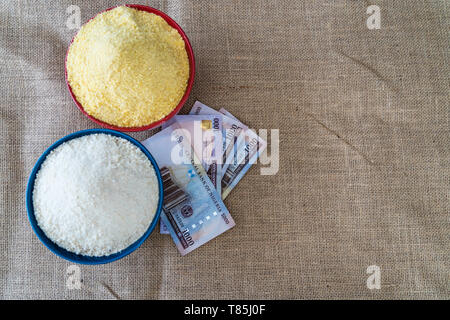 Nigerian yellow and white Garri in Bowls at marketplace - ready to sell Stock Photo