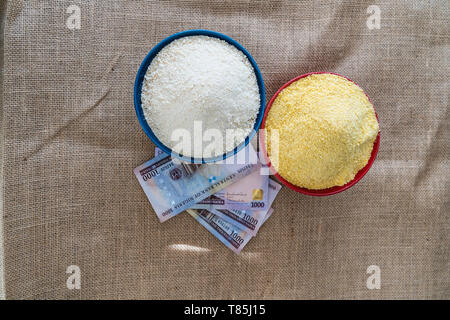 Nigerian yellow and white Garri in Bowls at marketplace - ready to sell Stock Photo