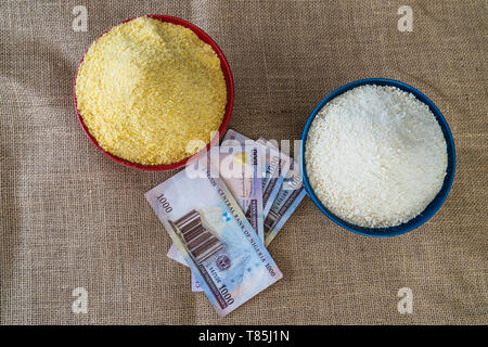 Nigerian yellow and white Garri in Bowls at marketplace - ready to sell Stock Photo