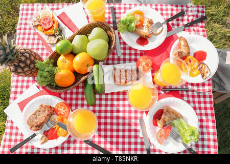 Tasty food on table outdoors. Summer picnic Stock Photo