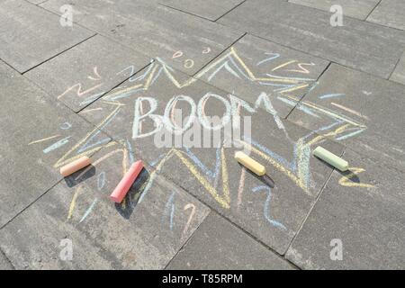 Text Boom drawing crayons on gray asphalt, top view Stock Photo
