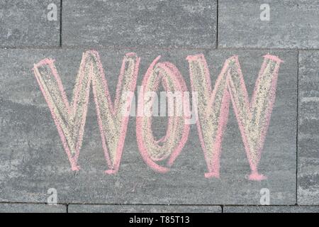 Wow written on gray sidewalk, top view. Stock Photo