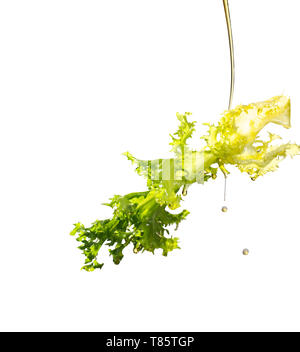 Oil pouring on frisee lettuce leaf Stock Photo