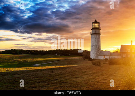 The Highland Lighthouse against a beautiful sunset in North Truro Massachusetts on the Cape Cod National Seashore.