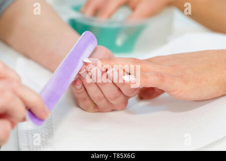 Woman having manicure Stock Photo