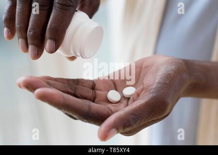 Woman pouring pills Stock Photo