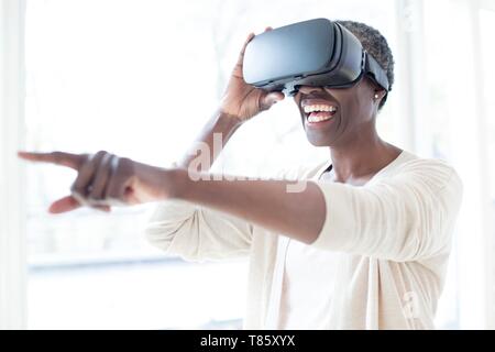 Woman wearing VR headset Stock Photo