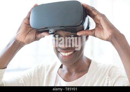 Woman wearing VR headset Stock Photo