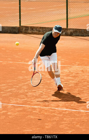 Active senior man playing tennis Stock Photo