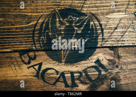Black Bacardi white rum logo painted on rustic weathered wood Stock Photo
