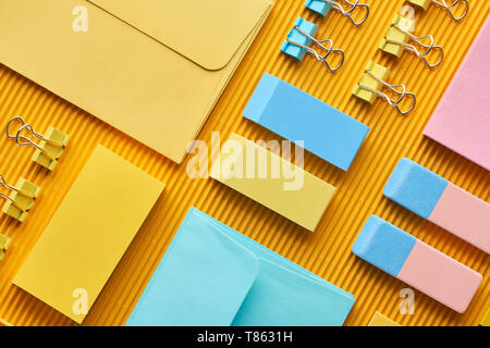 top view of colorful office stationery supplies on yellow Stock Photo