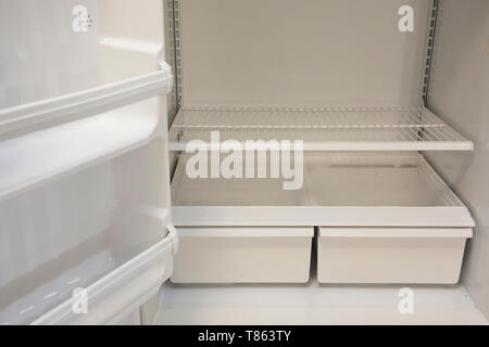 Bottom shelves and crisper in an empty refrigerator Stock Photo