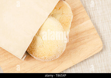 Bread and butter sweet in paper bag on wooden. Stock Photo