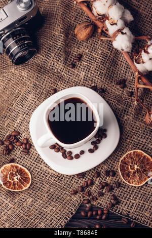 Coffee and cotton retro camera on sacking Still life with the top view Stock Photo