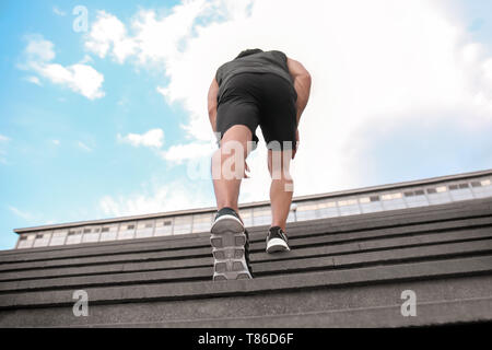 Sporty young man training outdoors Stock Photo