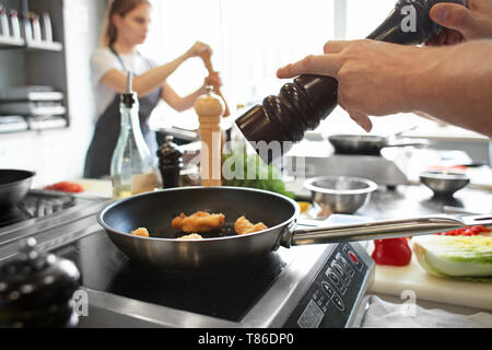 Male chef cooking in restaurant kitchen, closeup Stock Photo