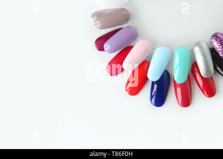 Nail polish samples in different bright colors. Colorful nail lacquer manicure swatches. Top view of nail art wheel palette. Stock Photo