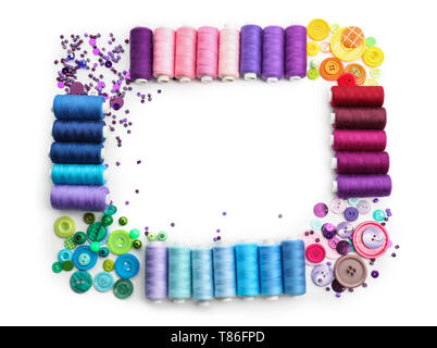 Composition with sewing threads and buttons on white background Stock Photo