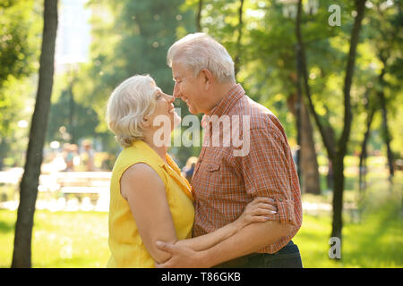 Happy mature couple in city park Stock Photo