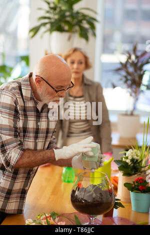 Nice good looking aged man focusing on his work Stock Photo