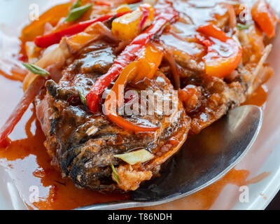 Deep fried fish with sweet and sour sauce, a popular dish across most of East and Southeast Asia. Shallow depth of field. Photo taken in the Philippin Stock Photo